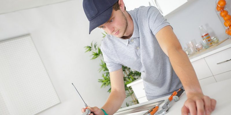 Plumber in residential kitchen