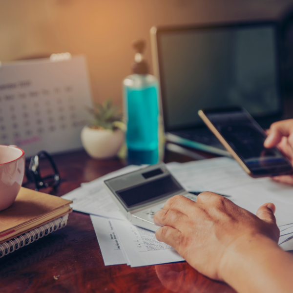 calculating tax in front of laptop